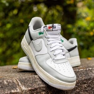 White and grey Nike Air with green accent